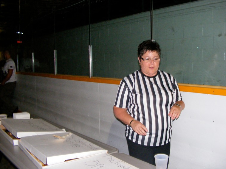 Kim showing off our referee shirts & serving up pizza