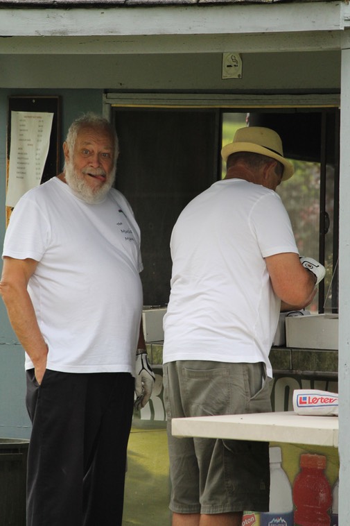 The guys are eating, while the girls are golfing!